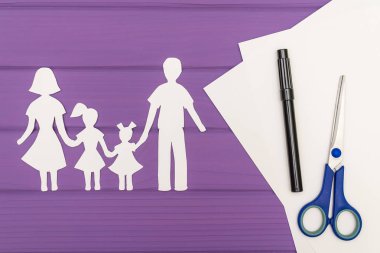 Erkek ve kadın iki kızla kağıt kesme siluetleri