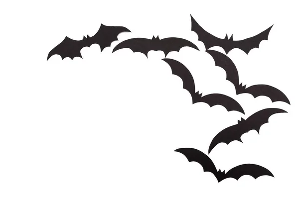 Silhouettes of volatile bats carved out of black paper are isolated on white — Stock Photo, Image