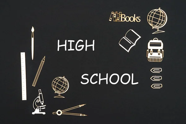 School supplies placed on black background with text high school — Stock Photo, Image