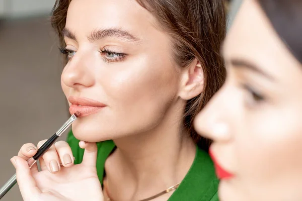 Makeup Καλλιτέχνης Εφαρμόζει Κραγιόν Στο Πρόσωπο Της Όμορφης Γυναίκας Μακιγιάζ — Φωτογραφία Αρχείου
