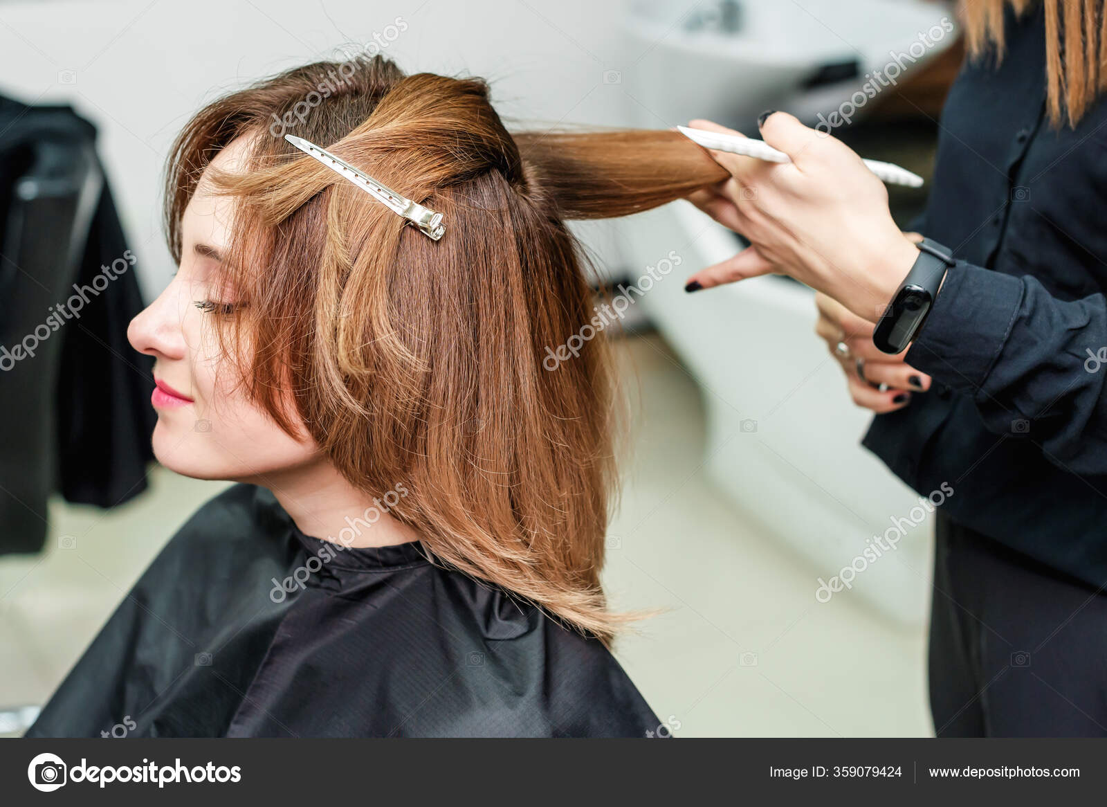 Cabeleireiro seca e modela o cabelo com um secador de cabelo no salão de  beleza