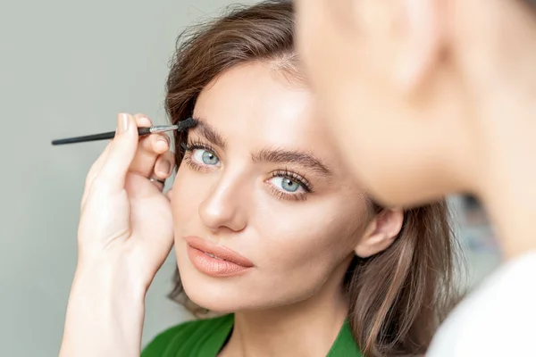 Eyebrows makeup for woman with eyebrow brush tool.