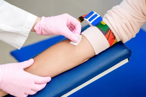 Nurse disinfecting arm skin by cotton before giving a injection vaccine in medical center.