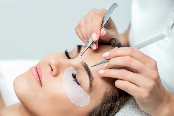 Cosmetologist Hands Holding Tweezers Face Young Woman Eyelash Extensions Procedure — Stock Photo, Image