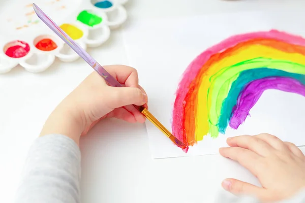 Top View Hands Child Drawing Rainbow Brushes Paints White Paper — Stock Photo, Image