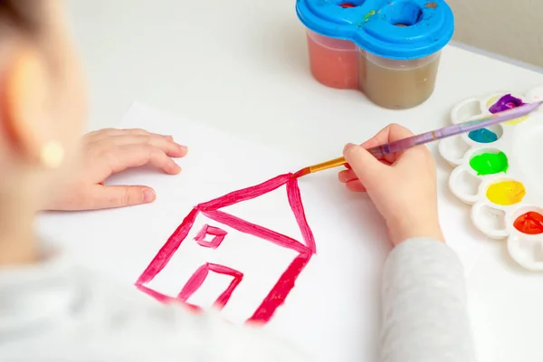 Die Hand Des Kindes Zeichnet Ein Hausdach Auf Weißem Papier — Stockfoto