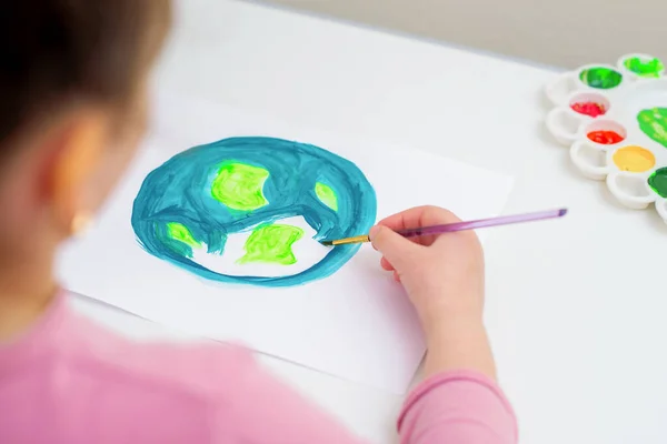 子供は白い紙の上に水彩で世界の地図を持つ惑星地球を描きます 平和と地球の日の概念 — ストック写真