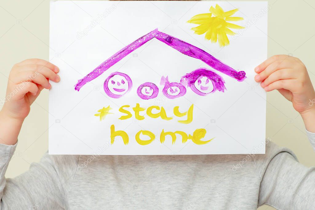 Child is holding a picture of family silhouette under the roof and words Stay Home covering her face on yellow background. Stay Home concept.