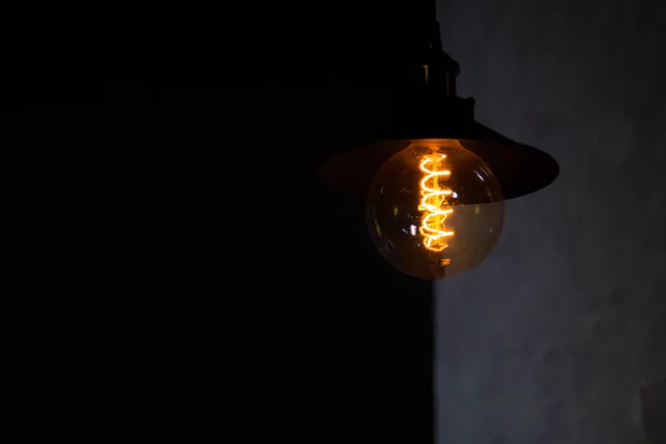 Decorative warm light bulb with dark background in a a restaurant