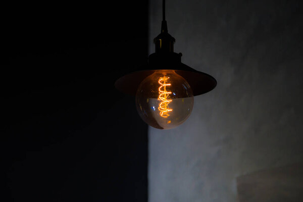 Decorative warm light bulb with dark background in a a restaurant