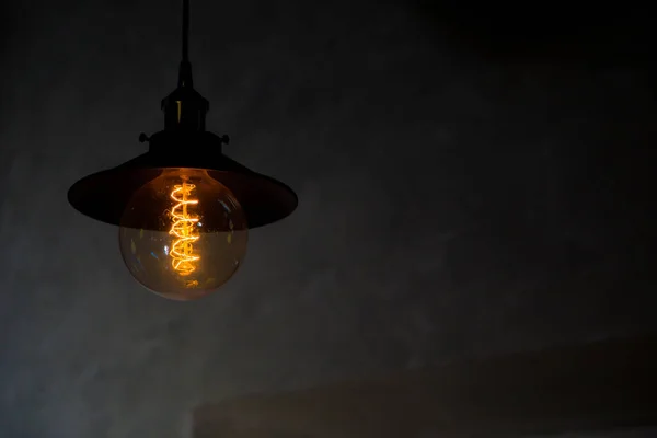 Decorative warm light bulb with dark background in a a restaurant