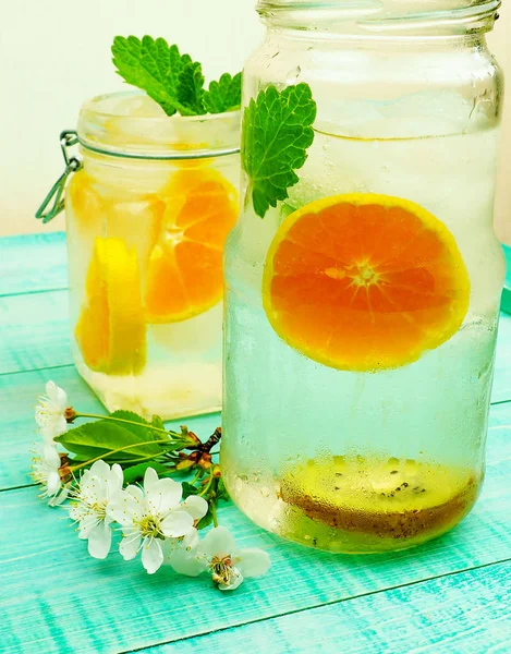 Orange cold drink with mint, vertical, selective focus — Stock Photo, Image