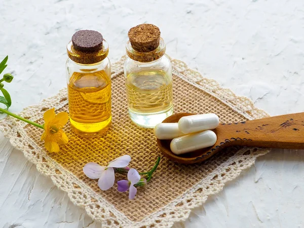 Bottle of essential oil with fresh herbal sage, setup with flat lay on blue wooden table. alternative medicine, health, vitamins