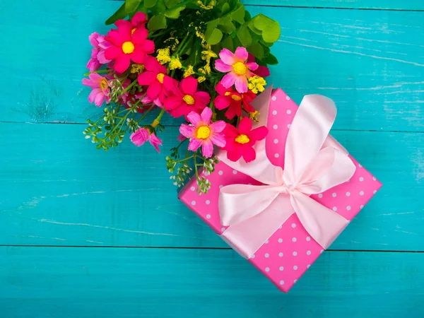 Ahşap zemin üzerine çiçek ve yayla hediye kutuları. Dekorasyon.