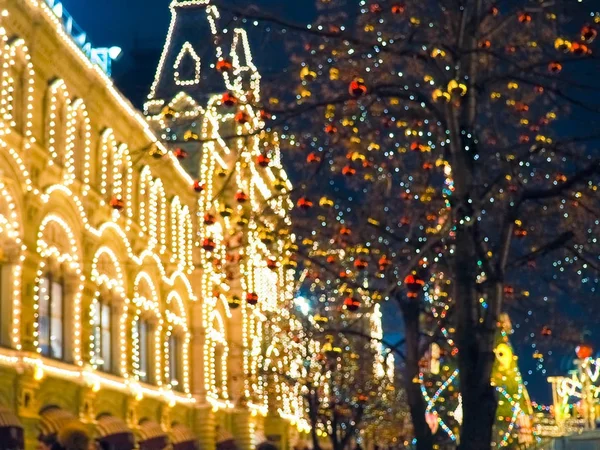 Festive illuminations in the streets of the city, Tree with bright red and yellow balls.