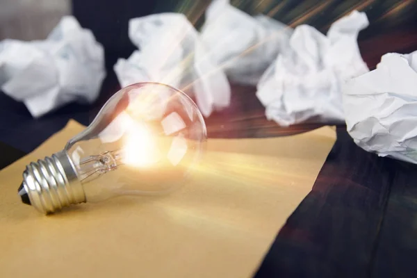 Great idea concept with crumpled paper and light bulb on wooden table, Inspiration concept , Great idea Stock Image