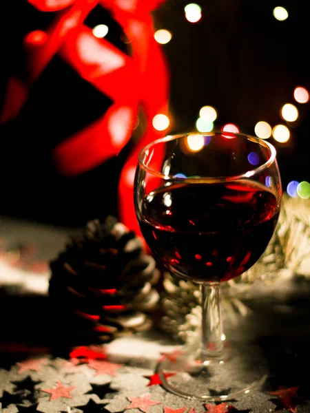 Holiday background with glasses of red wine , Red wine and Christmas ornaments on wooden table — Stock Photo, Image