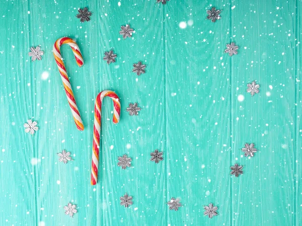 Christmas candy cane. two Christmas candy cane with frame on blue wooden background, space for text. Christmas composition, postcard