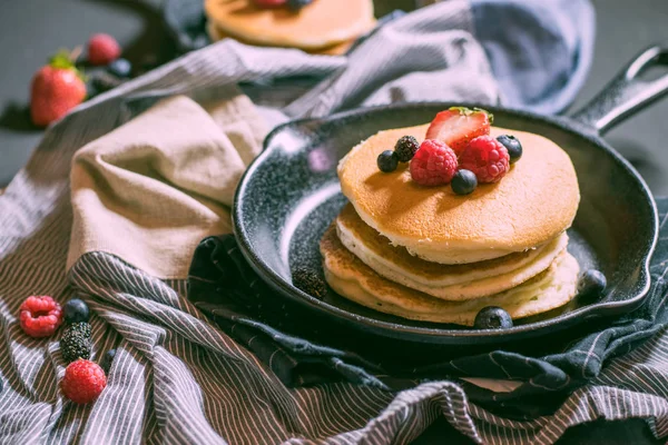 Home made pancakes with berries on metal frying pan decorated wi — Stock Photo, Image