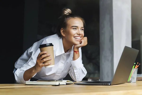 Hermosa joven mujer de negocios trabajando remotamente desde casa. Mujer sonriente se sienta delante de la computadora portátil —  Fotos de Stock