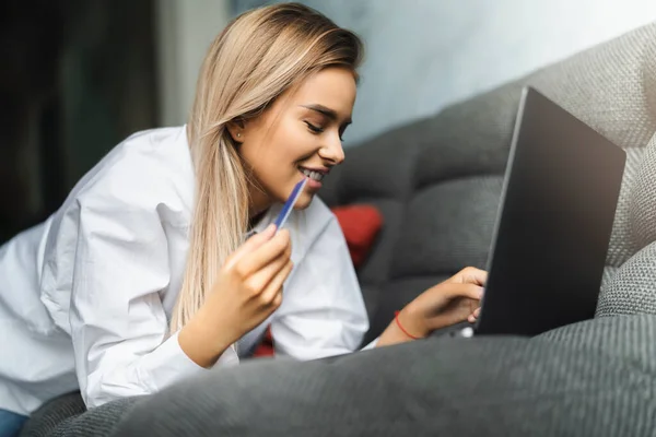 Mooie blonde vrouw met bankkaart om te betalen voor online gekochte goederen. Veilige betalingsdiensten voor klanten — Stockfoto