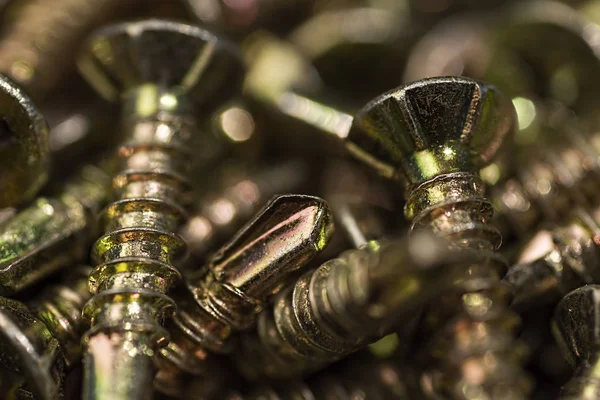 Tornillos dorados Macro Close Up. Patrón de fondo . — Foto de Stock