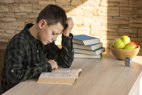 Young Boy Reading Book and Studying on Table at Home — Stock Photo, Image