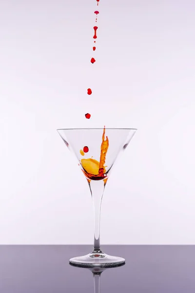 Cocktail rouge éclaboussures de verre Martini isolé sur fond blanc. Bar Commerciaux Concept . — Photo