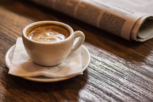 Coffee Cup and Newspaper on a Wooden Table. Good Morning or Coffee Break Concept. — Stock Photo, Image