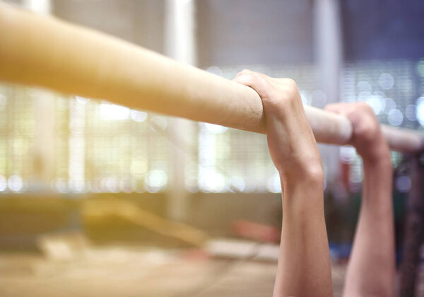 blue and orange filtered shot of child hanging on horizontal bar