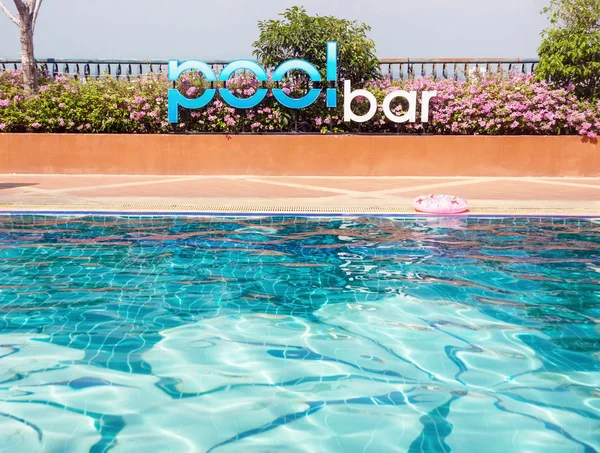 Neon sign Pool bar in outdoor swimming pool. Travel, relax, party