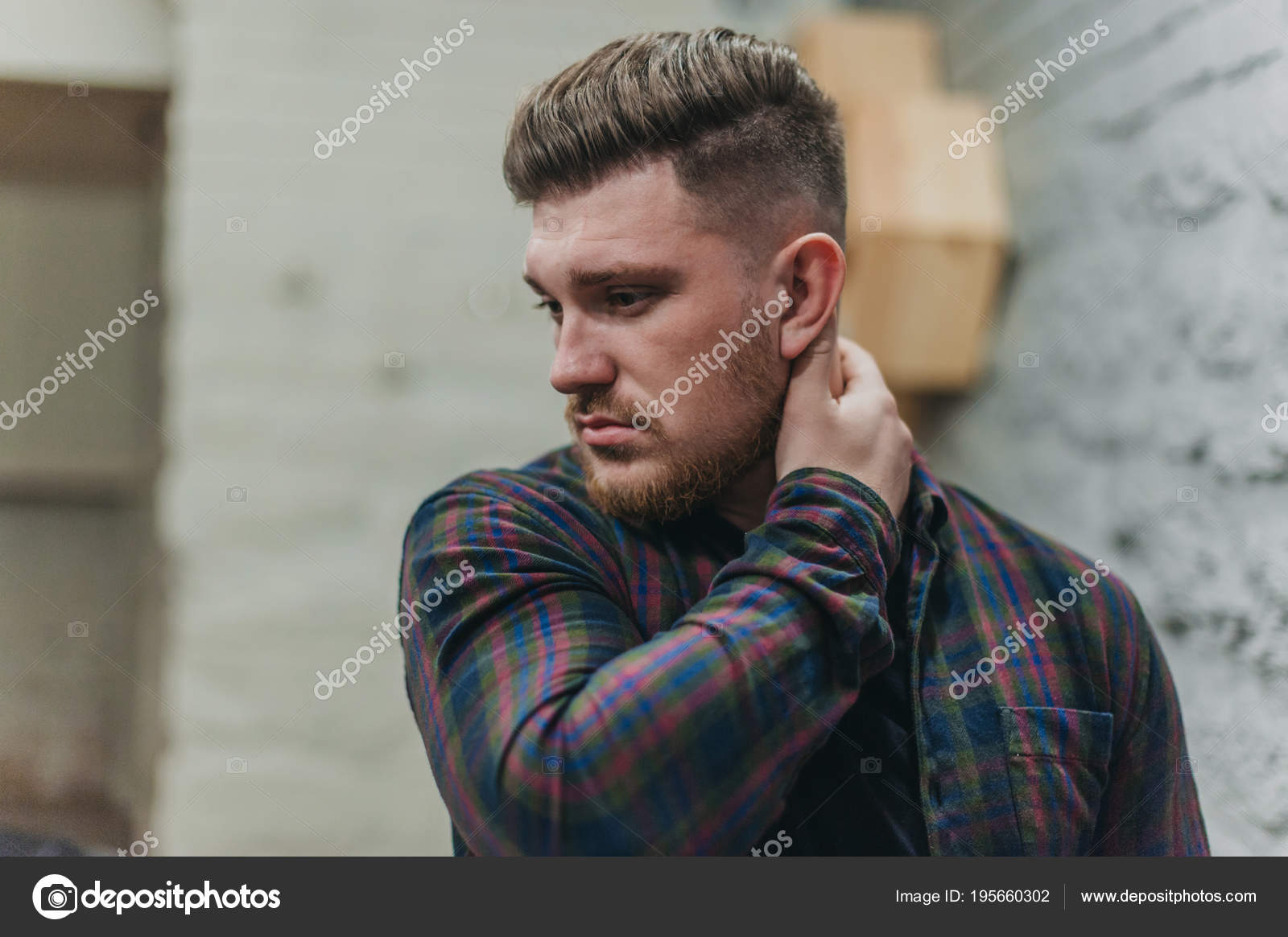 A Man In A Barber Shop For Haircuts And Shaving Stock Photo