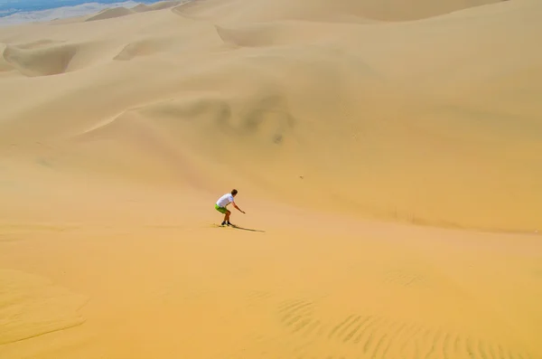 Sand-boarding fun on Atacama Desert, Oasis of Huacachina, Ica Region, Peru