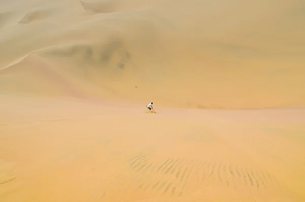 Sand-boarding fun on Atacama Desert, Oasis of Huacachina, Ica Region, Peru