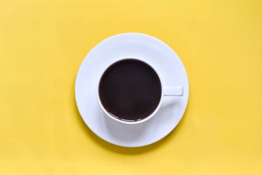 Bir fincan kahve sarı bir arka plan (tablo üzerinde)