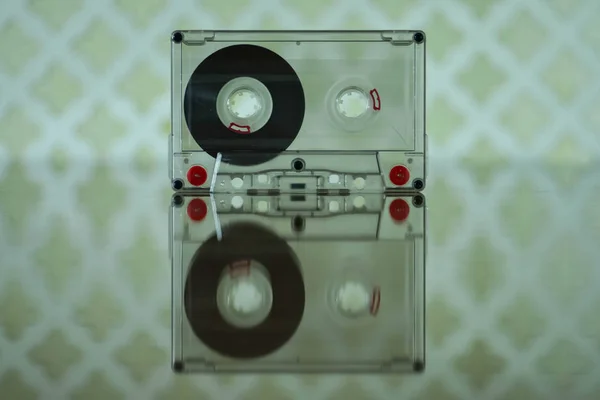 Compact audio cassette with reflection