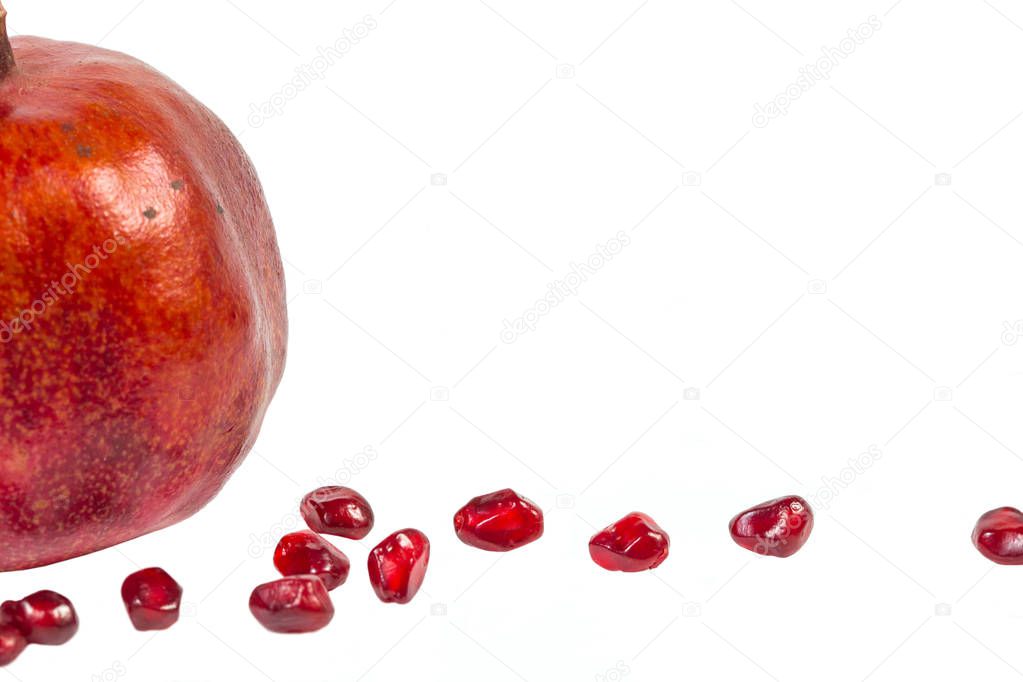 Red Garnet seeds on white. Isolated object for design layouts
