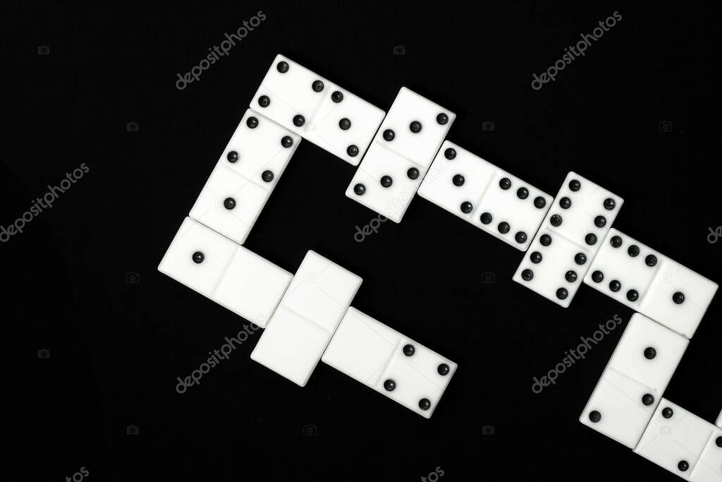 White dominoes chips combination on the black