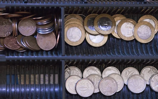 Brazilian money coins inside the electronic cash register