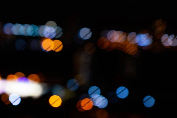 Bokeh city lights in black background. Color overlay light pattern