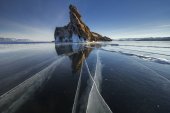 Картина, постер, плакат, фотообои "lake is covered with a thick layer of ice. ice story. stone rock sticking out from under the piles of ice. the cleanest lake in the world, lake baikal", артикул 134049256
