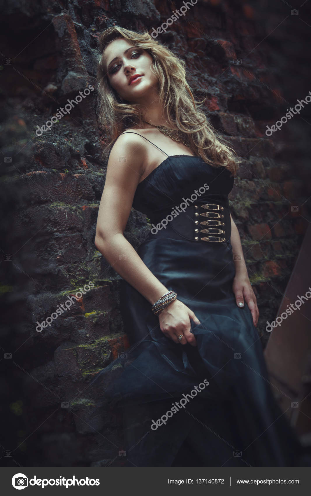 Blonde girl in black dress at an old abandoned factory. steampunk ...