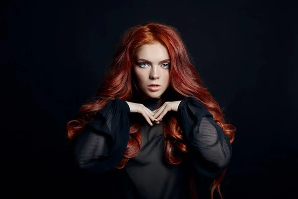 Beautiful woman with red hair on a black background. Portrait of — Stock Photo, Image