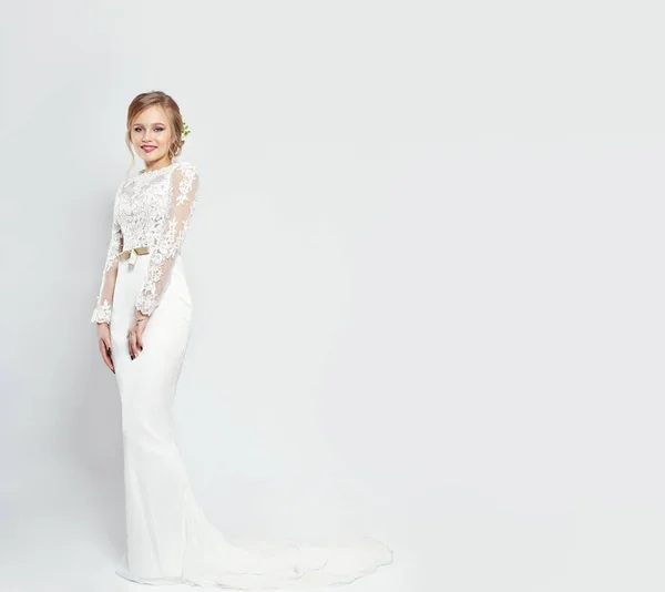 Brud i lång vit brudklänning på en vit bakgrund. Lyxig klänning i en kvinnas kropp. Flickan förbereder sig för att gifta sig med. Perfekt bild och klä kvinnor. — Stockfoto