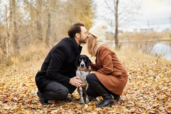 Casal apaixonado no dia dos namorados andando no parque com o cão. O amor e a ternura entre um homem e uma mulher. Dia dos Namorados é um feriado de todos os amantes . — Fotografia de Stock