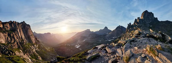 Panoramic photo of the spring mountain valley natural Park Ergaki, Russia. Fabulous sunrise and sunset in the mountains, amazing nature, spring in the mountains. Travel and hike.