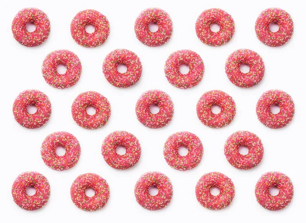 Colagem de rosquinhas rosadas em esmalte sobre um fundo branco. Lotes d — Fotografia de Stock