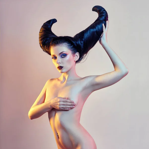 Nude art woman with hair in the form of horns, a female demon wi — Stock Photo, Image