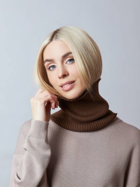 Boynunda Snood atkısı olan güzel sarışın kadın. Bahar elbiseli kız, kalın kazaklı.