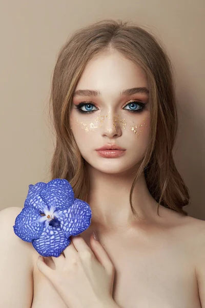 난초를 여성의 아름다운 초상화 꽃잎으로 만들어 화장품 소녀의 얼굴을 깨끗하게 — 스톡 사진
